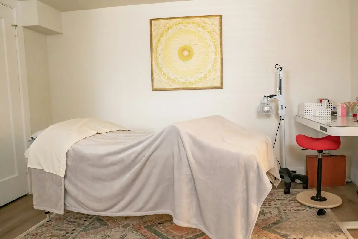 Ketamine-assisted psychotherapy room with bed covered by sheet in the Underground Sanctuary